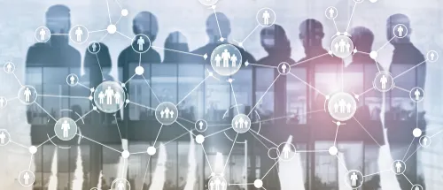 複数の人の影にオフィスビルと人間のつながりを表したイラストが重なる