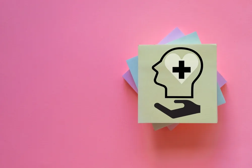 ピンクの背景に置かれた、脳を守るイメージのイラストのカード